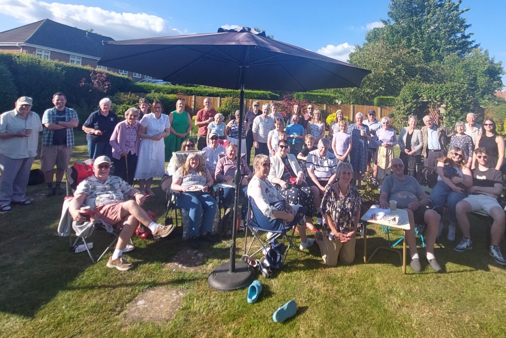 Friends enjoying a cream tea at a community fundraiser